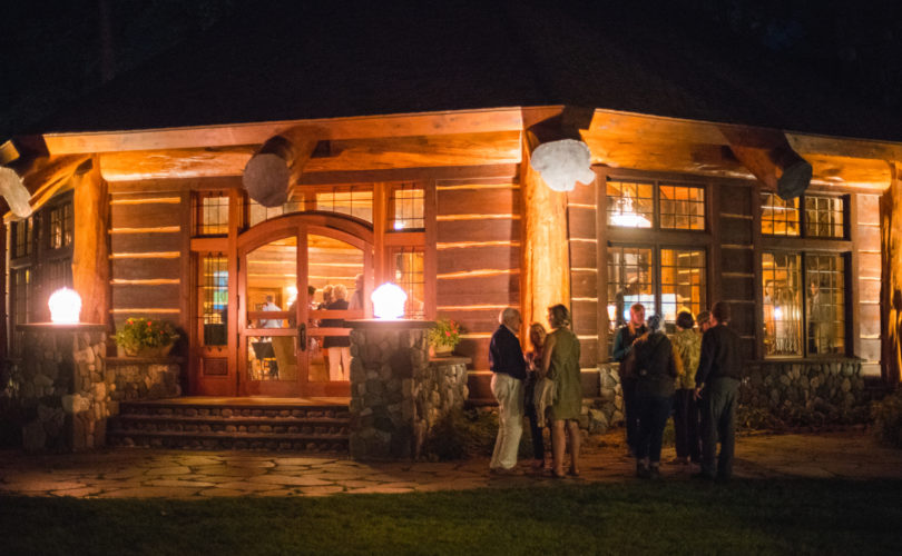 Night view of people socializing at the Red Crown Lodge